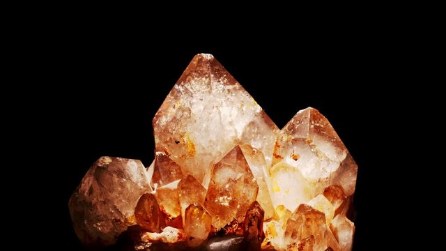 Cluster of brown smoky quartz crystals and black background