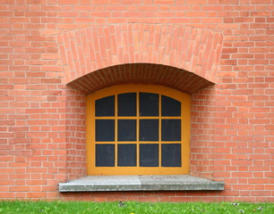 A basement window with a metal barrier