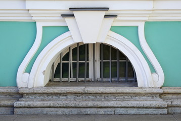 A basement window with a metal barrier