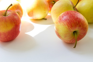 close up sweet summer red apples on a white home table background