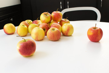 Juicy red and yellow apples on white table  home healthy food cooking concept