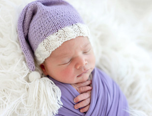 Cute newborn in knitted hat