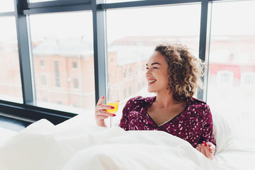 Woman on Hotel Bed Covering Self With Sheet.