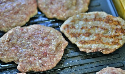burgers on a grill, fast food concept,