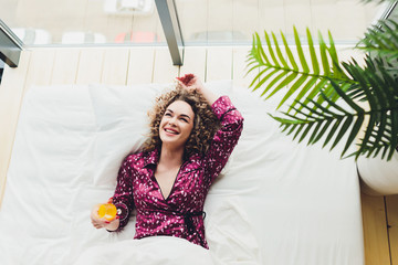 Woman on Hotel Bed Covering Self With Sheet.