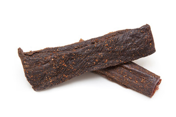 Beef Biltong, South African Beef Jerky isolated on a white studio background.