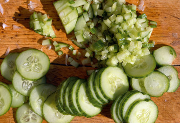 
sliced ​​fresh cucumbers lie on a cutting board