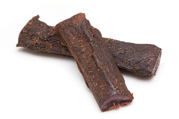 Beef Biltong, South African Beef Jerky isolated on a white studio background.