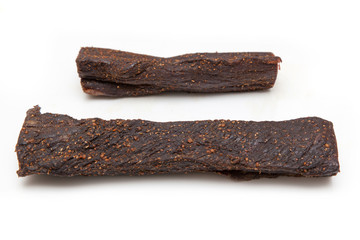Beef Biltong, South African Beef Jerky isolated on a white studio background.
