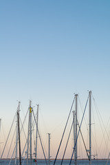 Boat masts at sunset with pastel colors. Nautical and sea concept.  