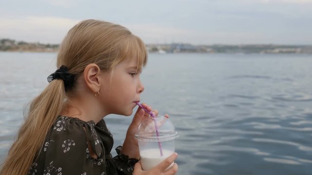 Cheerful laughing girl of 8 years old, with long, bright by the sea.
