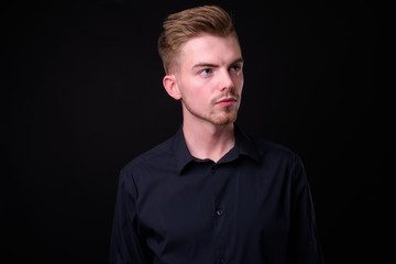 Portrait of young handsome blond bearded businessman