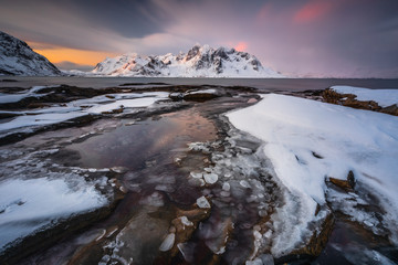 Soft tones of the golden hour in mountains at the coast of Vareid, Lofoten, Norway
