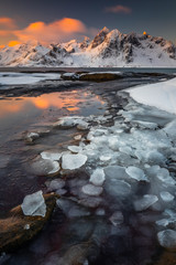 Soft tones of the golden hour in mountains at the coast of Vareid, Lofoten, Norway

