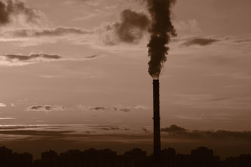 Black smoke from an industrial chimney as a symbol of environmental pollution
