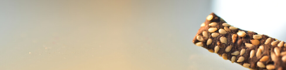 sesame seed-studded chocolate cake with bokeh background and focus selection, available space for text, web banners concepts