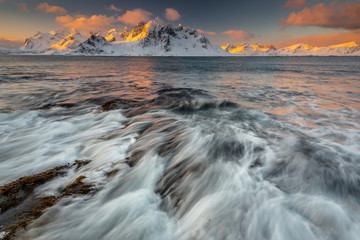 Soft tones of the golden hour in mountains at the coast of Vareid, Lofoten, Norway
