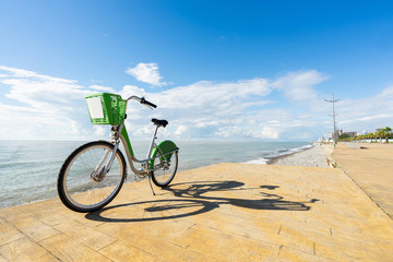 Fototapeta premium Bicycle on boulevard with blue sky and sea background.