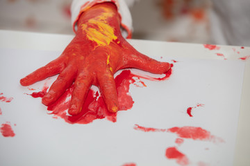 Close up young boy painting with colorful hands. Art, creativity and painting concept