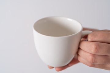 hand holding a cup of coffee on white background isolate, Asia woman hand with white coffee.