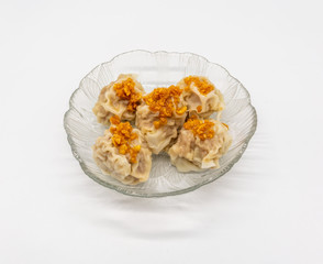 Chinese traditional delicacies, fresh meat wontons on clear plate isolated on white