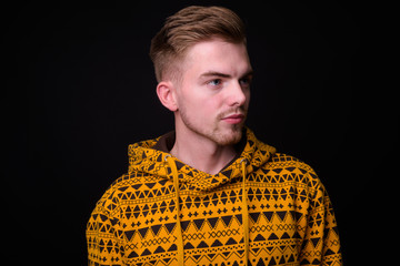 Portrait of young blond bearded man wearing hoodie