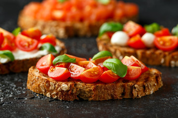 Bruschetta with cherry tomato and basil on rustic table