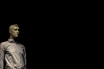 mannequin man in shirt isolated on black background