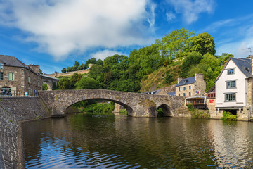 Fototapeta na wymiar Dinan, France. Stone bridge over the Rance river. In the background is a medieval fortress