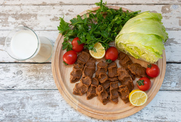 Cig kofte (raw meatball in Turkish) with lettuce, tomato, pickle and lemon, hot Chee kofta. Turkish local raw food concept