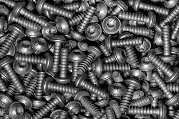 A huge arrenge of taping metal or iron screws, screws background, wallpaper, texture, industrial background and concept