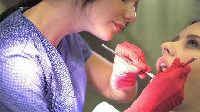 Female dentist doing dental treatment to her patient in clinic