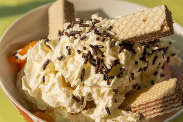 A sundae with cream and waffle
