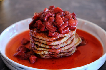 Stack of Vegan Pancakes with Homemade Strawberry Sauce. Delicious and healthy homemade breakfast.