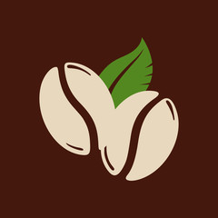 Two roasted coffee beans with a leaf