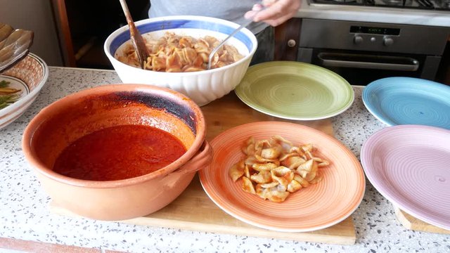 Homemade Italian orecchiette pasta dressed with ragù sauce.(ragout) ragù cooked in a terracotta pan - traditional Bolognese recipe