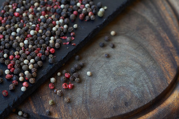 Pepper spice texture. Multicolored pepper corns, mix of colorful grains. Selective focus.