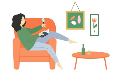 A girl sits in an armchair, reads a book and drinks wine from a glass.