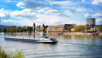 Promenade in Koblenz am Rhein with the former Prussian government building and shipping traffic on...