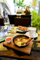 Breakfast with shakshuka and bruschetta and coffee and glass of wine