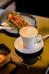 Breakfast with shakshuka and bruschetta and cup of cappuccino