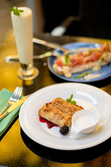 Breakfast with thin pancakes and bruschetta and smoothie