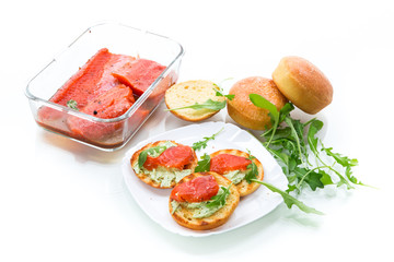 sandwich with fried bun, cheese spread and red fish in a plate