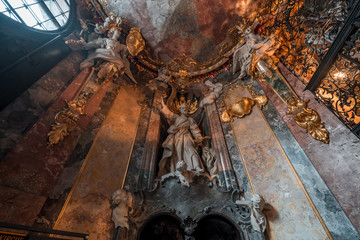 St Peter / Petrus statue with two angels on top in entrance hall to Baroque church Asamkirche in...