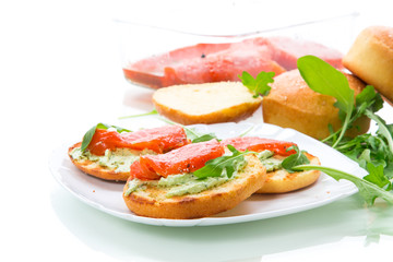 sandwich with fried bun, cheese spread and red fish in a plate