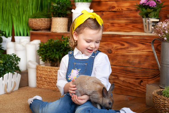 Little Girl With White Rabbit. Child Playing With Pet Bunny. Kids Play With Animals. Child At Easter Egg Hunt. Cute Little Girl With White Bunny In Garden.
Kid Take Care Of Pet. Spring Easter Garden.