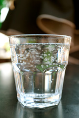 Vertical image of a glass of soda water isolated on black table