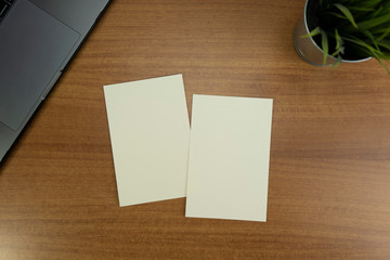 Empty white Postcard size paper with wood background and objects for mockup purposes
