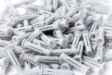 Lot of plastic dowels on a white background