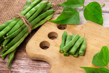 Green beans close up on wooden background